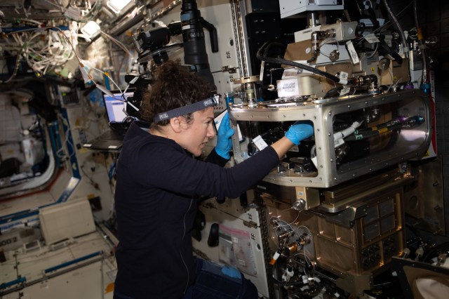 iss062e014339 (Feb. 16, 2020) --- NASA astronaut and Expedition 62 Flight Engineer Jessica Meir configures the Light Microscopy Module inside the Fluids Integrated Rack. The specialized microscope is being readied to examine the transition of an ordered crystal to a disordered glass to determine how increasing disorder affects structural and dynamic properties. The Advanced Colloids Experiment-Temperature-4 (ACE-T-4) investigation controls disorder by controlling temperature in a series of samples and observes the microscopic transition in three dimensions.