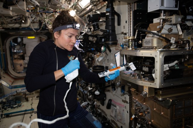 iss062e014349 (Feb. 16, 2020) --- A view of NASA astronaut Jessica Meir configuring the Light Microscopy Module (LMM) for the Advanced Colloids Experiment-Temperature-4 (ACE-T-4) science in the Destiny module aboard the International Space Station (ISS). Introducing disorder to a crystalline system in a controlled way can form glass. Advanced Colloids Experiment-Temperature-4 (ACE-T-4) examines the transition of an ordered crystal to a disordered glass to determine how increasing disorder affects structural and dynamic properties.
