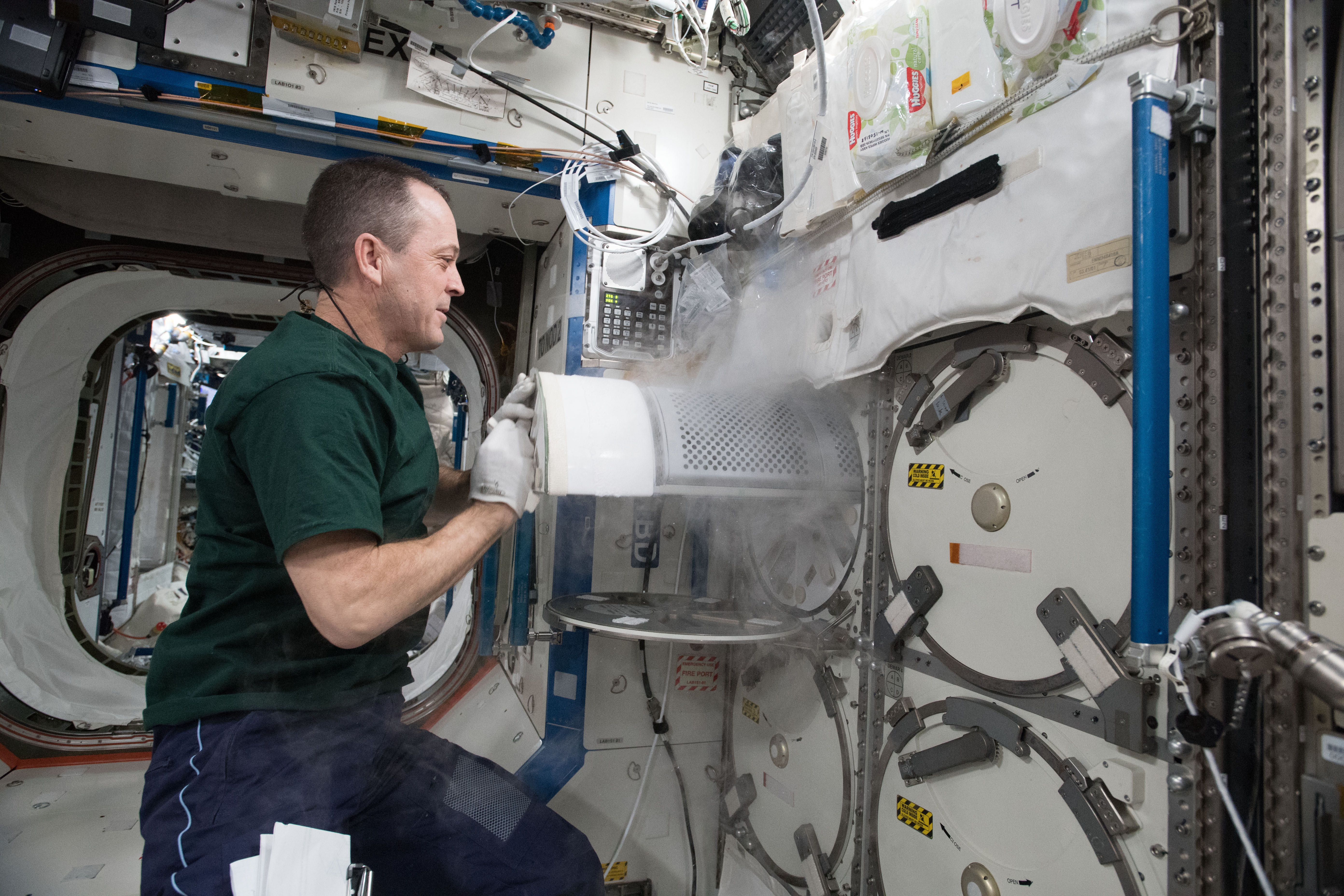 NASA astronaut Ricky Arnold transfers frozen biological samples from science freezers aboard the International Space Station to science freezers inside the SpaceX Dragon resupply ship. The research samples were returned to Earth aboard Dragon for retrieval by SpaceX engineers and analysis by NASA scientists.