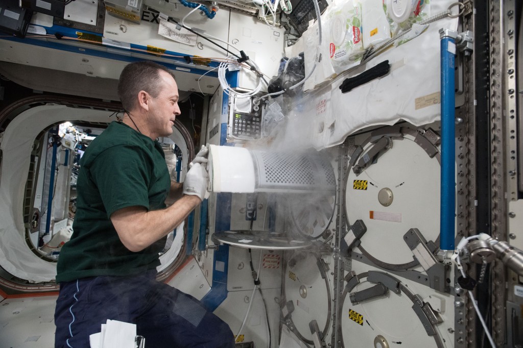 NASA astronaut Ricky Arnold transfers frozen biological samples from science freezers aboard the International Space Station to science freezers inside the SpaceX Dragon resupply ship. The research samples were returned to Earth aboard Dragon for retrieval by SpaceX engineers and analysis by NASA scientists.