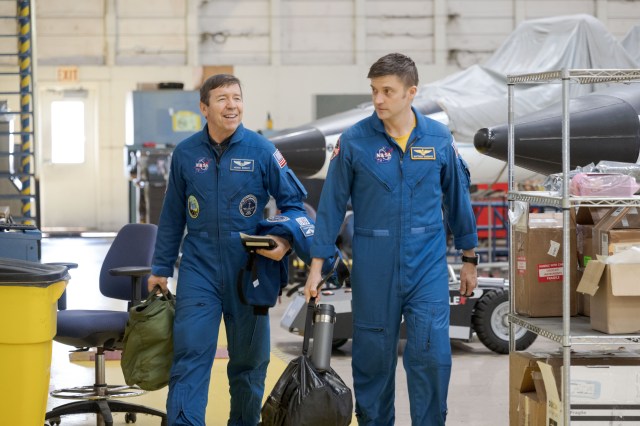 NASA astronauts (from left) Mike Barratt and Matthew Dominick, SpaceX Crew-8 Pilot and Commander respectively, walk together before a T-38 trainer jet flight at Ellington Field.