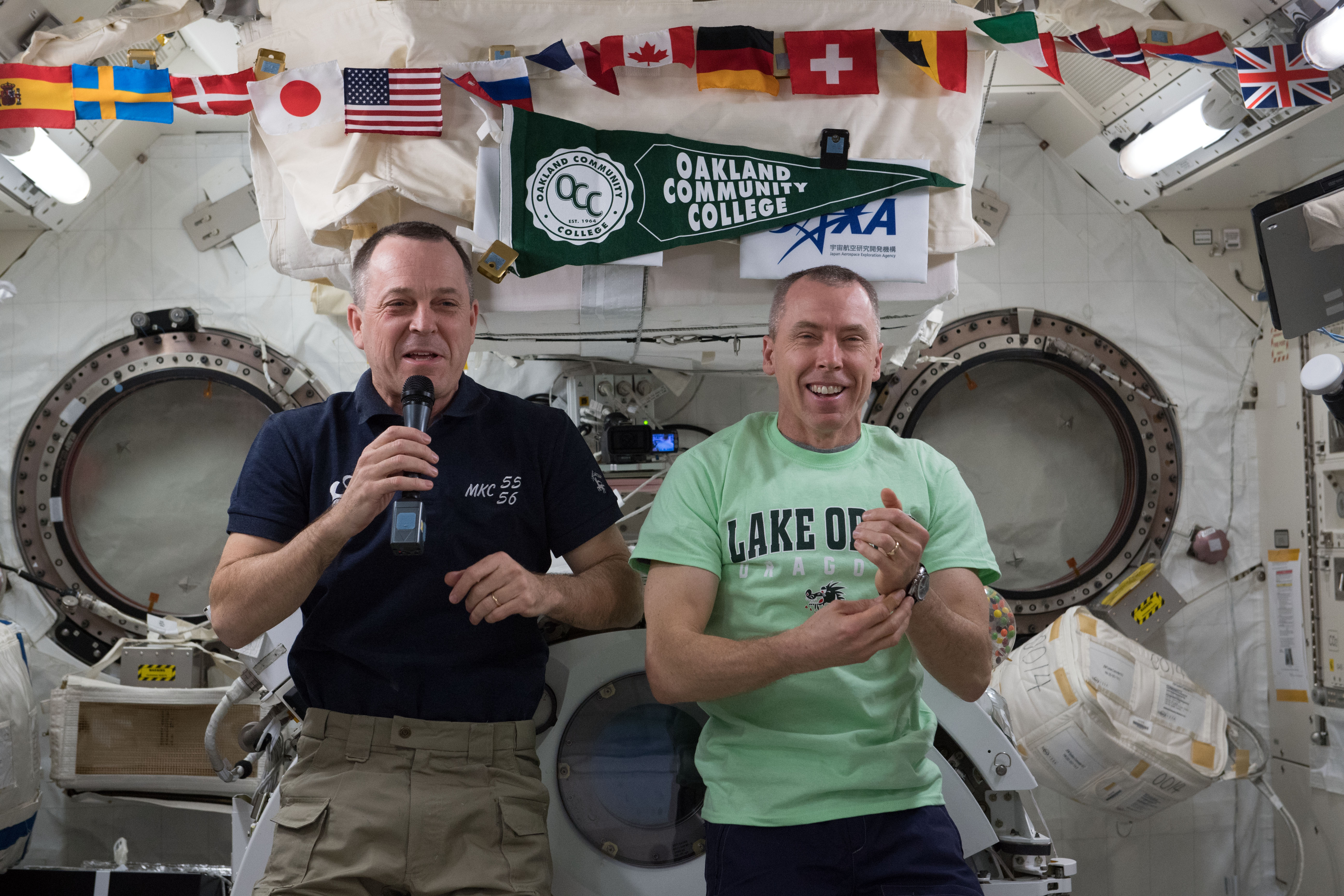 NASA astronauts Ricky Arnold (left) and Drew Feustel are pictured inside the Japanese Kibo laboratory module talking to high school and college students from Lake Orion, Mich.