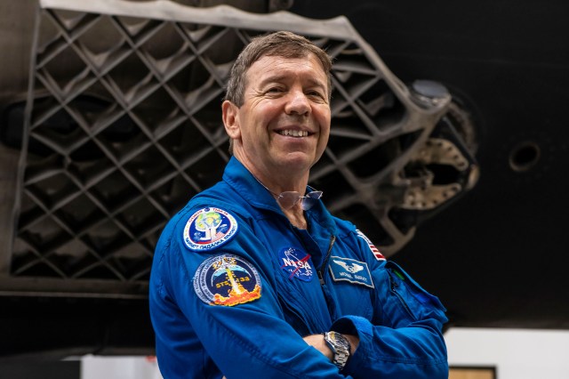 NASA's SpaceX Crew-8 Pilot Michael Barratt poses for a photo inside SpaceX Hangar X at the Kennedy Space Center in Florida. Hangar X supports Falcon 9 rocket refurbishment and houses administration offices.