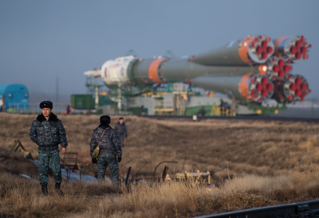 Security personnel are seen as the Soyuz rocket is rolled out by train to the launch pad, Monday, March 19, 2018 at the Baikonur Cosmodrome in Kazakhstan. Expedition 55 crewmembers Ricky Arnold and Drew Feustel of NASA and Oleg Artemyev of Roscosmos are scheduled to launch at 1:44 p.m. Eastern time (11:44 p.m. Baikonur time) on March 21 and will spend the next five months living and working aboard the International Space Station.