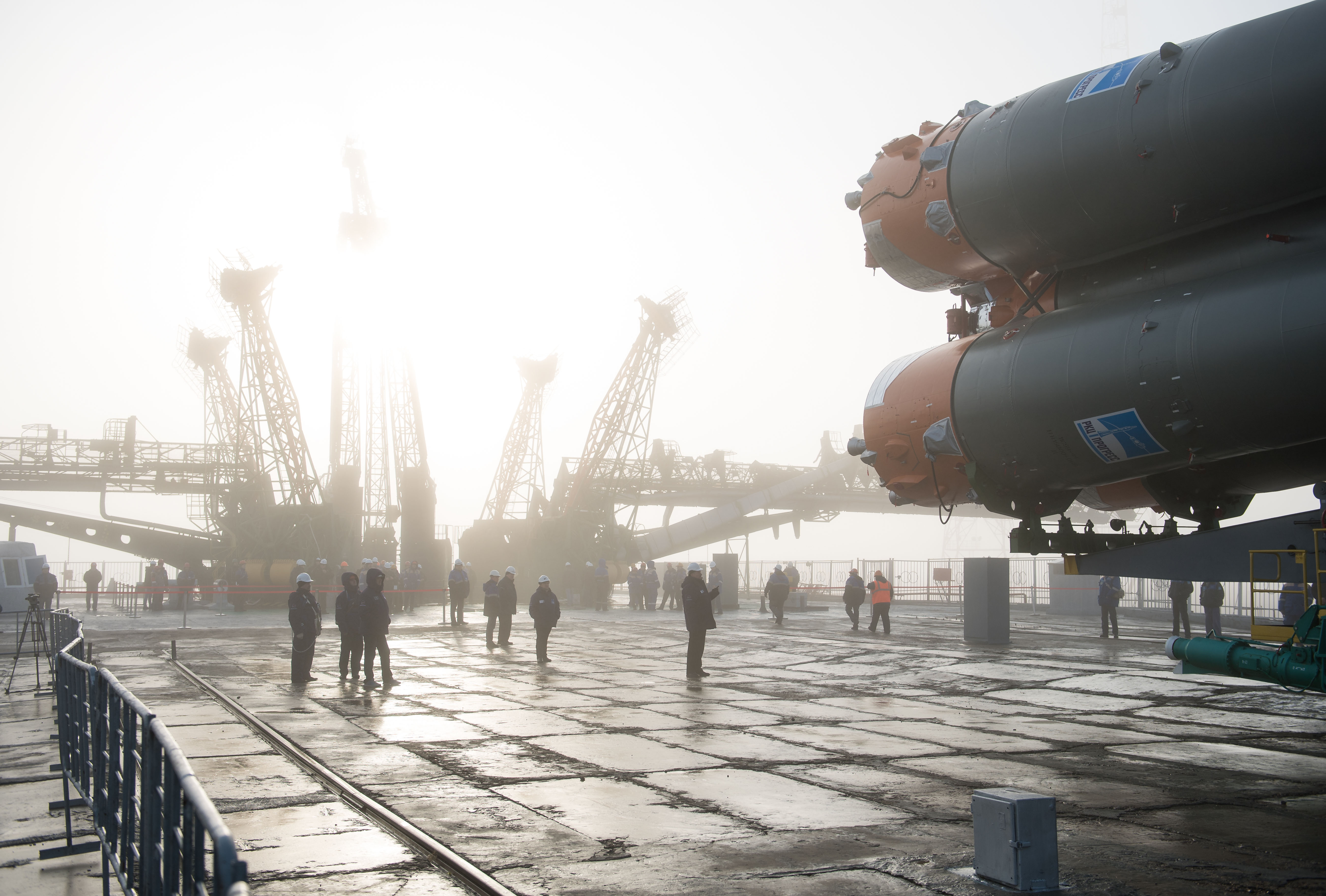 Workers are seen on the launch pad as the Soyuz rocket arrives after being rolled out by train, Monday, March 19, 2018 at the Baikonur Cosmodrome in Kazakhstan. Expedition 55 crewmembers Ricky Arnold and Drew Feustel of NASA and Oleg Artemyev of Roscosmos are scheduled to launch at 1:44 p.m. Eastern time (11:44 p.m. Baikonur time) on March 21 and will spend the next five months living and working aboard the International Space Station.