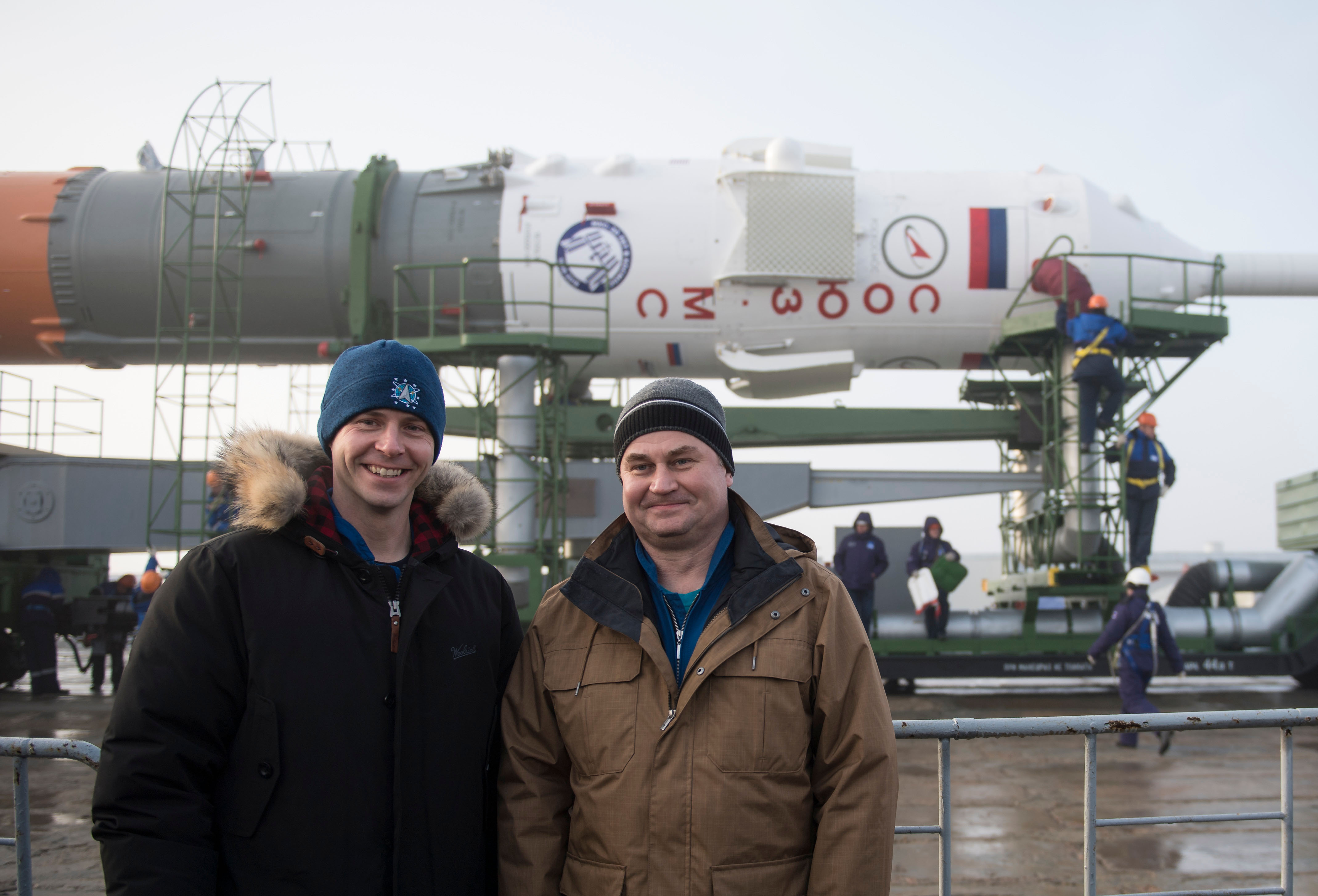 Expedition 55 backup crew members Nick Hague of NASA, left, and Alexey Ovchinin of Roscosmos pose for a picture as the Soyuz rocket is rolled out to the pad, Monday, March 19, 2018 at the Baikonur Cosmodrome in Kazakhstan. Expedition 55 crewmembers Ricky Arnold and Drew Feustel of NASA and Oleg Artemyev of Roscosmos are scheduled to launch at 1:44 p.m. Eastern time (11:44 p.m. Baikonur time) on March 21 and will spend the next five months living and working aboard the International Space Station.