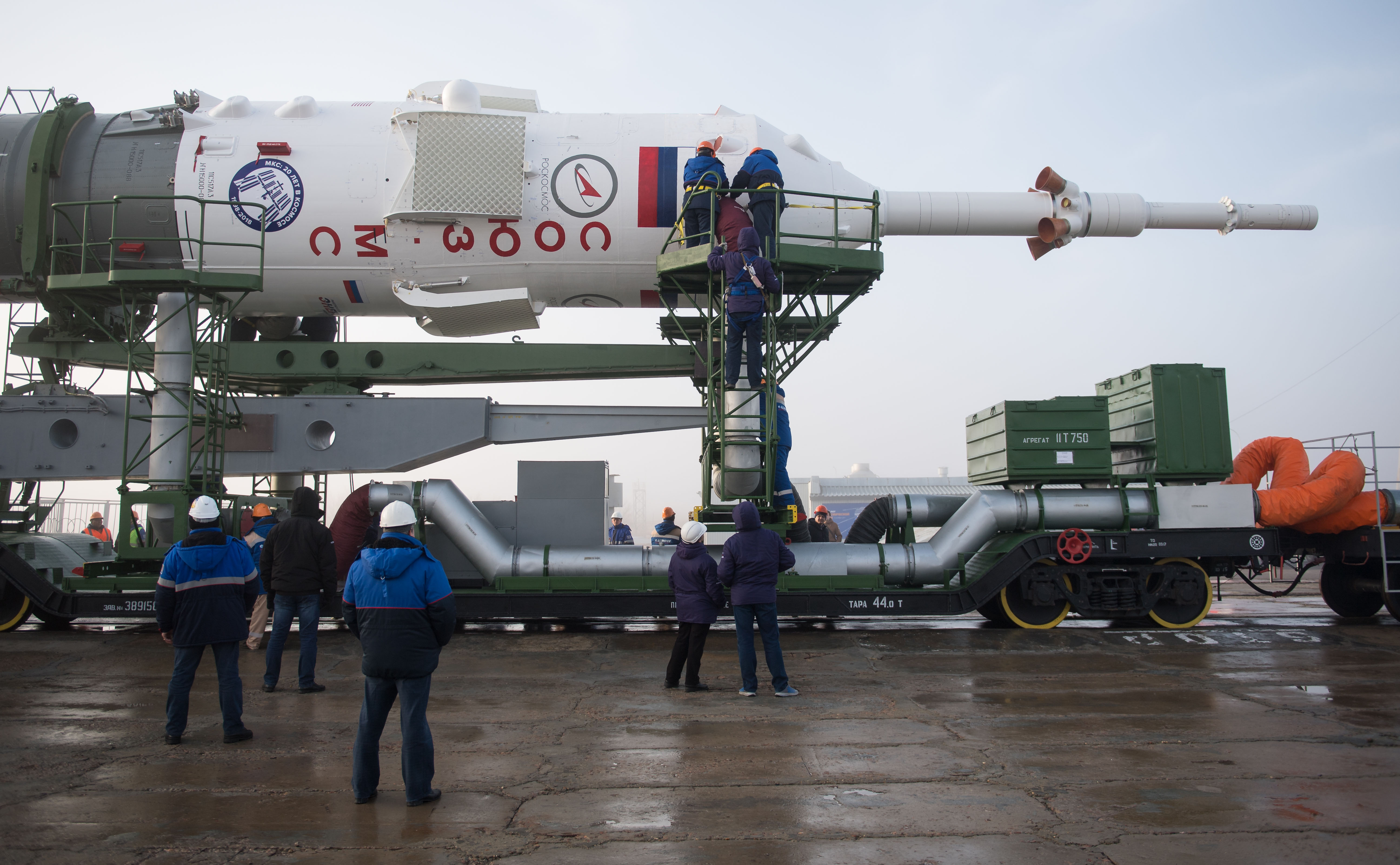 Workers prepare to raise the Soyuz rocket into a vertical position on the pad, Monday, March 19, 2018 at the Baikonur Cosmodrome in Kazakhstan. Expedition 55 crewmembers Ricky Arnold and Drew Feustel of NASA and Oleg Artemyev of Roscosmos are scheduled to launch at 1:44 p.m. Eastern time (11:44 p.m. Baikonur time) on March 21 and will spend the next five months living and working aboard the International Space Station.