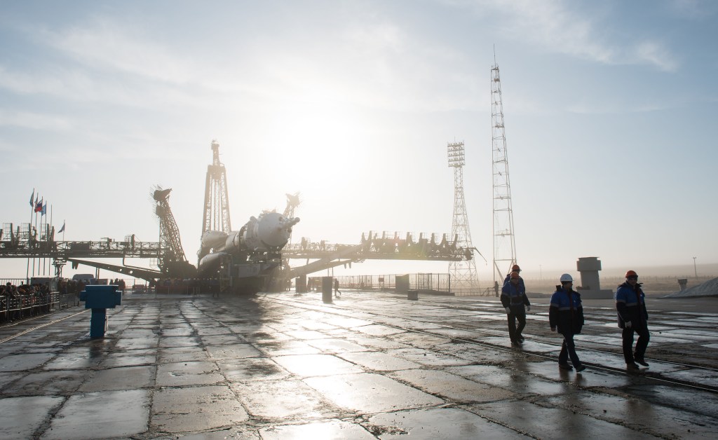 Workers prepare to raise the Soyuz rocket into a vertical position on the pad, Monday, March 19, 2018 at the Baikonur Cosmodrome in Kazakhstan. Expedition 55 crewmembers Ricky Arnold and Drew Feustel of NASA and Oleg Artemyev of Roscosmos are scheduled to launch at 1:44 p.m. Eastern time (11:44 p.m. Baikonur time) on March 21 and will spend the next five months living and working aboard the International Space Station.