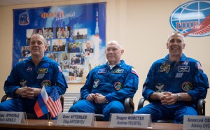 Expedition 55 flight engineer Ricky Arnold of NASA, left, Soyuz Commander Oleg Artemyev of Roscosmos, center, and flight engineer Drew Feustel of NASA, right, are seen in quarantine, behind glass, during a press conference, Tuesday, March 20, 2018 a the Cosmonaut Hotel in Baikonur, Kazakhstan. Arnold, Artemyev, and Feustel are scheduled to launch to the International Space Station aboard the Soyuz MS-08 spacecraft on Wednesday, March 21.