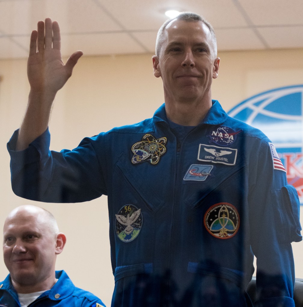 Expedition 55 flight engineer Drew Feustel is seen in quarantine, behind glass, during a press conference, Tuesday, March 20, 2018 a the Cosmonaut Hotel in Baikonur, Kazakhstan. Feustel, Soyuz Commander Oleg Artemyev of Roscosmos, and flight engineer Ricky Arnold of NASA are scheduled to launch to the International Space Station aboard the Soyuz MS-08 spacecraft on Wednesday, March 21.