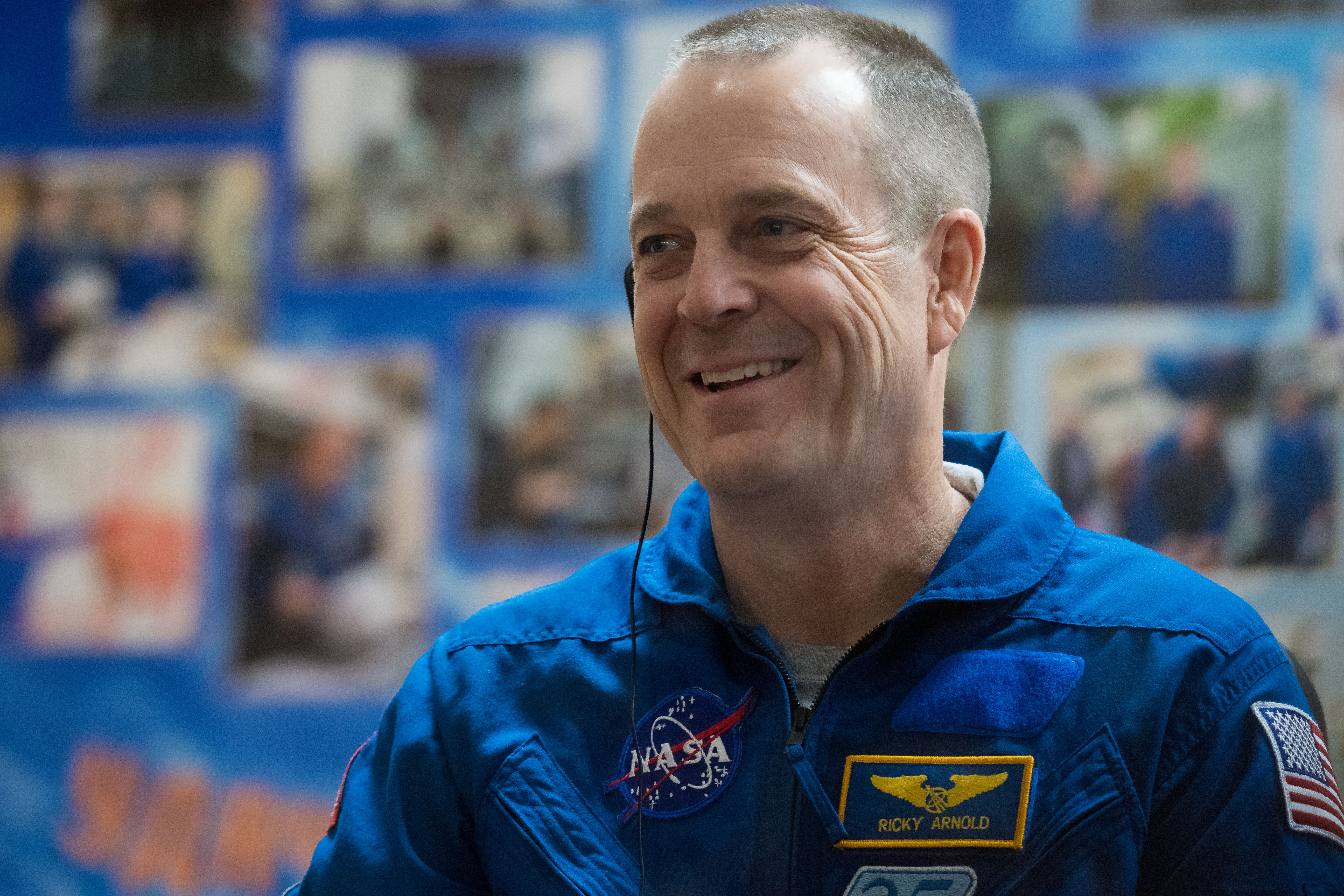 Expedition 55 flight engineer Ricky Arnold of NASA is seen in quarantine, behind glass, during a press conference, Tuesday, March 20, 2018 a the Cosmonaut Hotel in Baikonur, Kazakhstan. Arnold, Soyuz Commander Oleg Artemyev of Roscosmos, flight engineer Drew Feustal of NASA are scheduled to launch to the International Space Station aboard the Soyuz MS-08 spacecraft on Wednesday, March 21.
