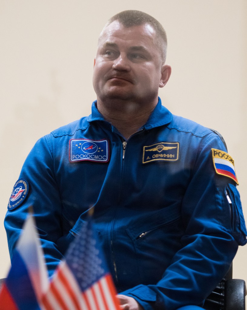 Expedition 55 backup crew member Alexey Ovchinin of Roscosmos is seen in quarantine, behind glass, during a press conference, Tuesday, March 20, 2018 a the Cosmonaut Hotel in Baikonur, Kazakhstan. Expedition 55 Soyuz Commander Oleg Artemyev of Roscosmos, flight engineer Ricky Arnold and flight engineer Drew Feustal of NASA are scheduled to launch to the International Space Station aboard the Soyuz MS-08 spacecraft on Wednesday, March 21.