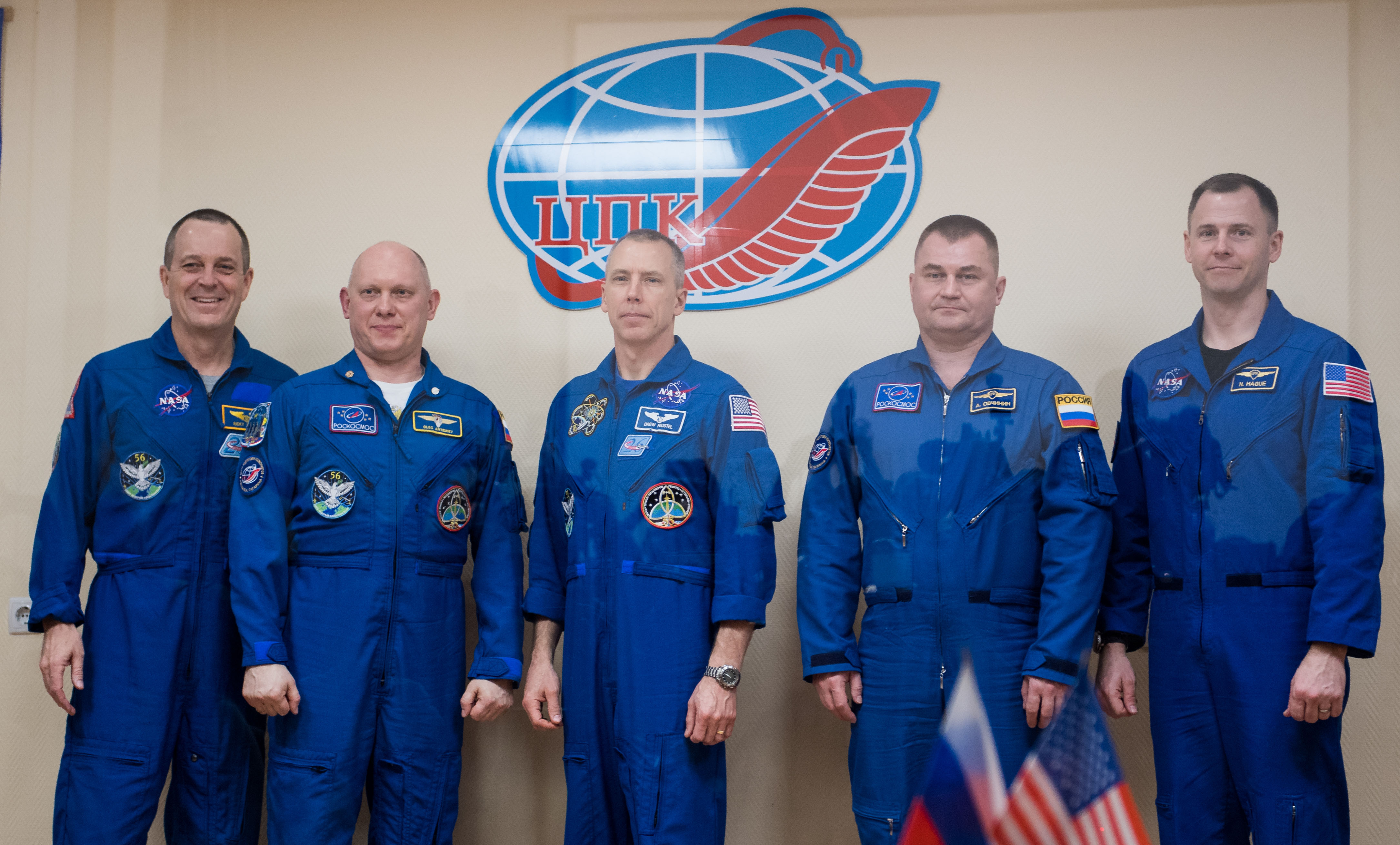 Expedition 55 prime crew members Ricky Arnold of NASA, left, Oleg Artemyev of Roscosmos, second from left, and Drew Feustel of NASA, center, pose for a picture with backup crew members Alexey Ovchinin of Roscosmos, second from right, and Nick Hague of NASA, right, at the conclusion of a press conference, Tuesday, March 20, 2018 a the Cosmonaut Hotel in Baikonur, Kazakhstan. Arnold, Artemyev, and Feustel are scheduled to launch to the International Space Station aboard the Soyuz MS-08 spacecraft on Wednesday, March 21.