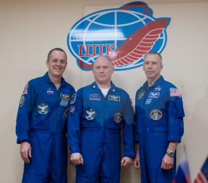 Expedition 55 flight engineer Ricky Arnold of NASA, left, Soyuz Commander Oleg Artemyev of Roscosmos, center, and flight engineer Drew Feustel of NASA, right, pose for a picture at the conclusion of a press conference, Tuesday, March 20, 2018 a the Cosmonaut Hotel in Baikonur, Kazakhstan. Arnold, Artemyev, and Feustel are scheduled to launch to the International Space Station aboard the Soyuz MS-08 spacecraft on Wednesday, March 21.