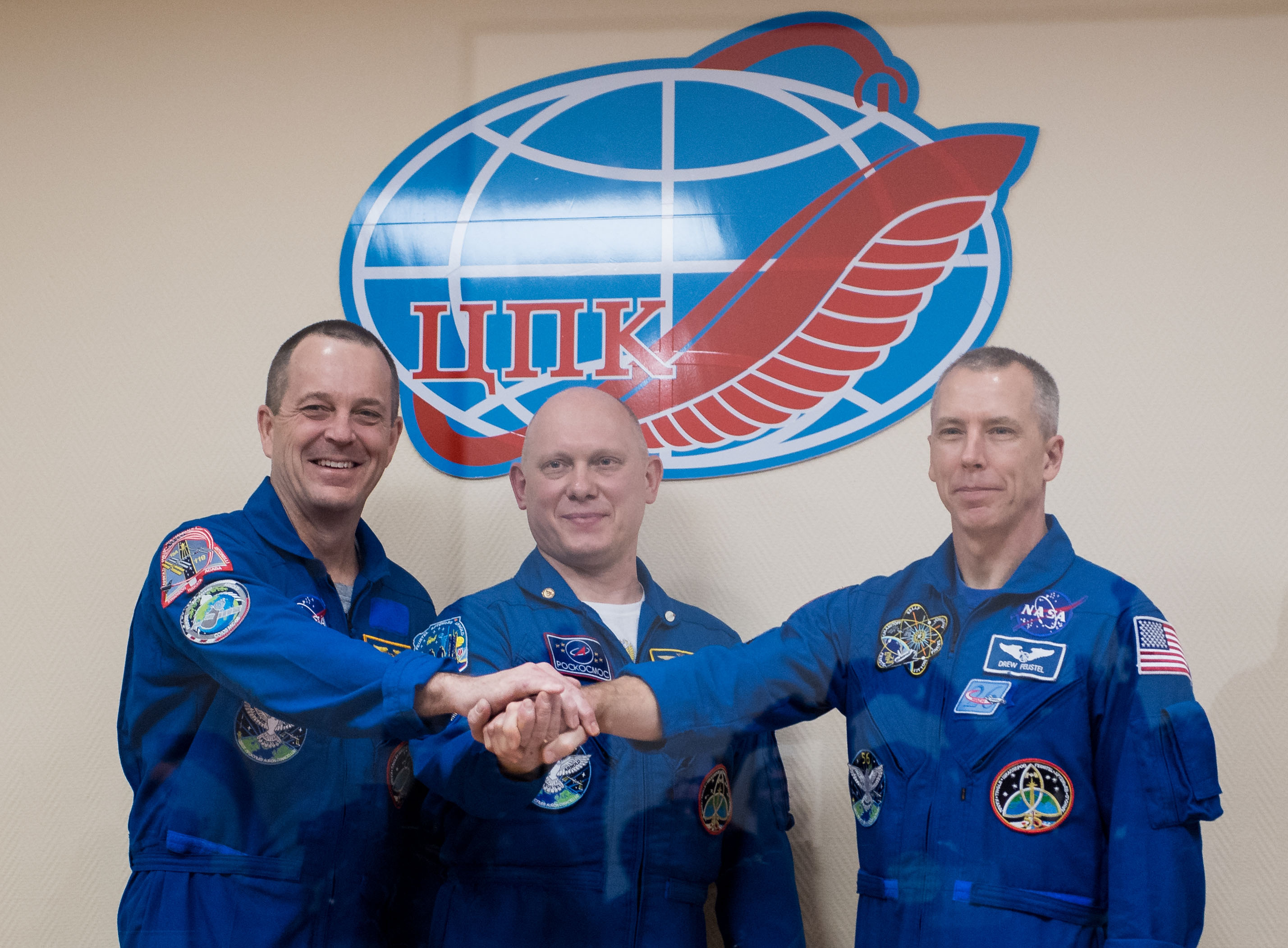 Expedition 55 flight engineer Ricky Arnold of NASA, left, Soyuz Commander Oleg Artemyev of Roscosmos, center, and flight engineer Drew Feustel of NASA, right, pose for a picture at the conclusion of a press conference, Tuesday, March 20, 2018 a the Cosmonaut Hotel in Baikonur, Kazakhstan. Arnold, Artemyev, and Feustel are scheduled to launch to the International Space Station aboard the Soyuz MS-08 spacecraft on Wednesday, March 21.
