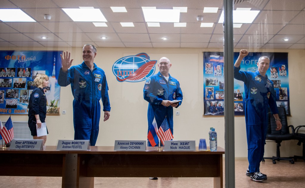 Expedition 55 flight engineer Ricky Arnold of NASA, left, Soyuz Commander Oleg Artemyev of Roscosmos, center, and flight engineer Drew Feustel of NASA, right, are seen at the conclusion of a press conference, Tuesday, March 20, 2018 a the Cosmonaut Hotel in Baikonur, Kazakhstan. Arnold, Artemyev, and Feustal are scheduled to launch to the International Space Station aboard the Soyuz MS-08 spacecraft on Wednesday, March 21.