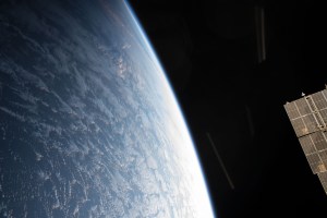 A portion of a Russian solar array peeks out on the side of this photograph of Earth as the International Space Station orbited off the northwest coast of Spain.