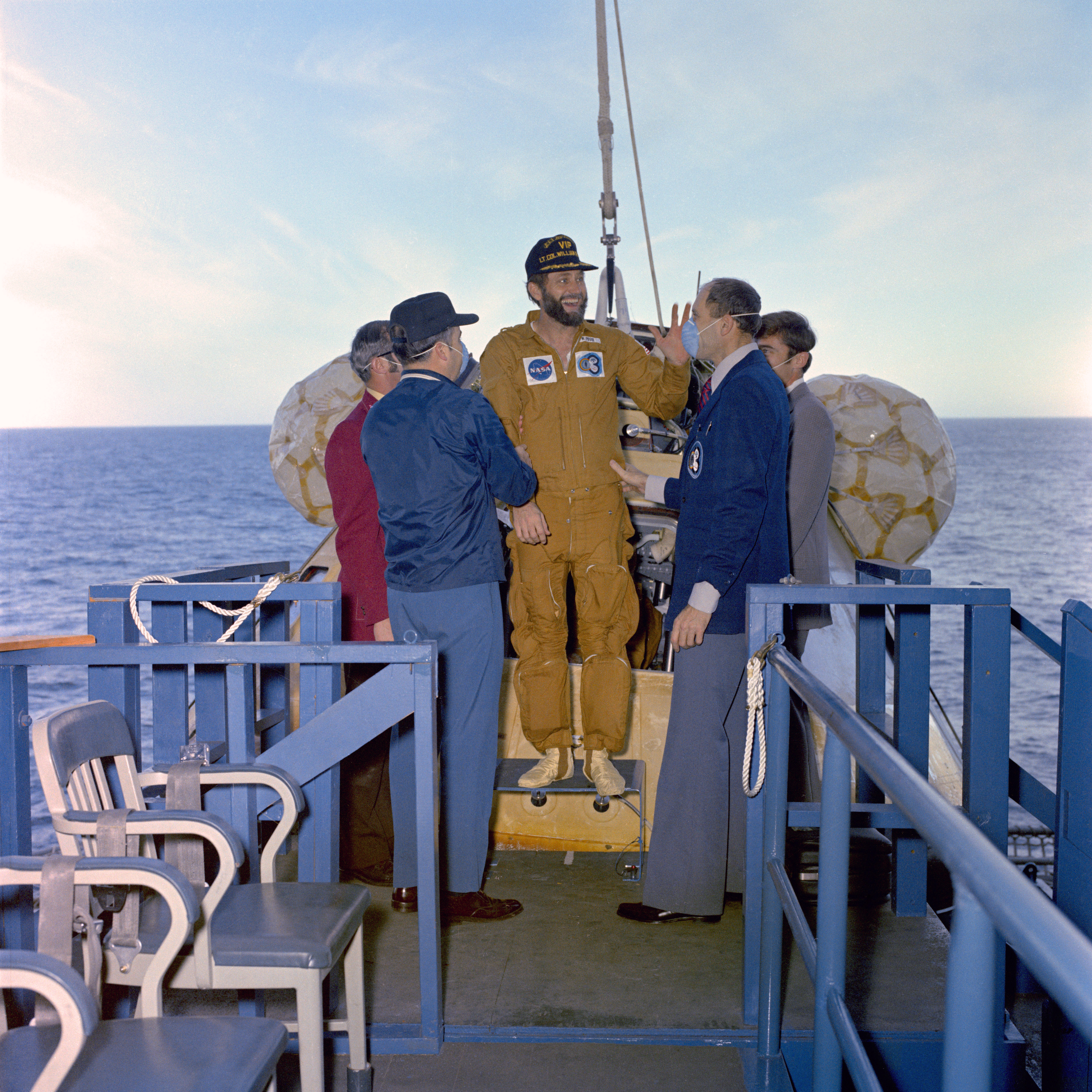 William R. Pogue stands after emerging from the Command Module