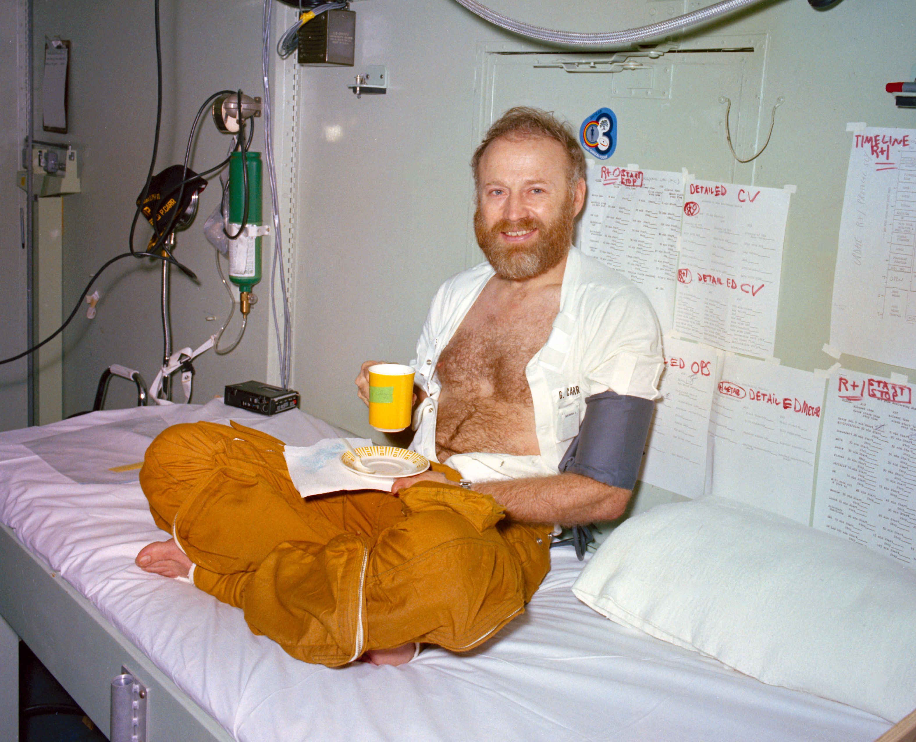 Skylab 4 Commander Gerald P. Carr enjoys a cup of coffee during medical testing aboard the U.S.S. New Orleans