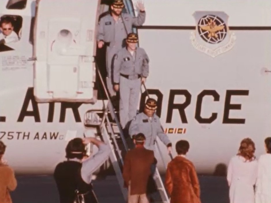 Skylab 4 astronauts Gerald P. Carr, bottom, Edward G. Gibson, and William R. Pogue descend the steps from the U.S. Air Force jet that had flown them from San Diego