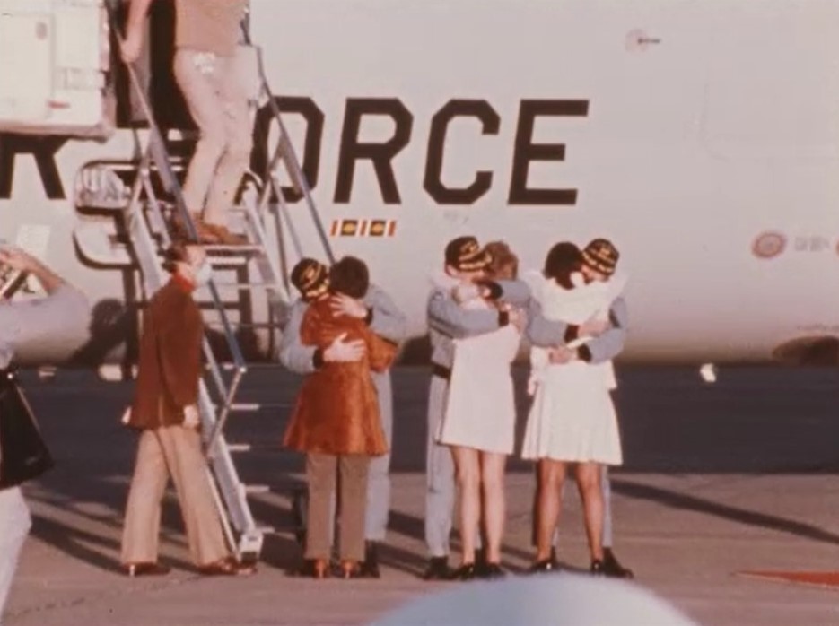 Pogue, left, Gibson, and Carr hug their wives for the first time in more than three months