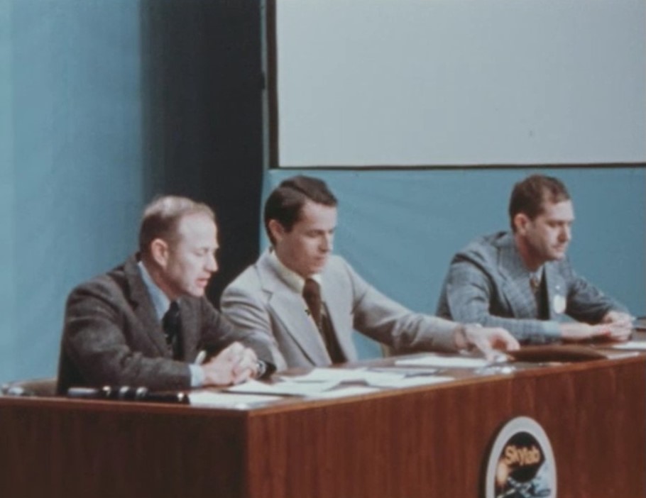 Gerald P. Carr, left, Edward G. Gibson, and William R. Pogue address reporters at their postflight press conference on Feb. 22