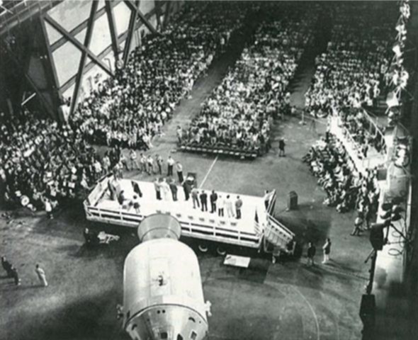 In April 1974, the Skylab 4 astronauts address the assembled employees in the Vehicle Assembly Building at NASA’s Kennedy Space Center in Florida