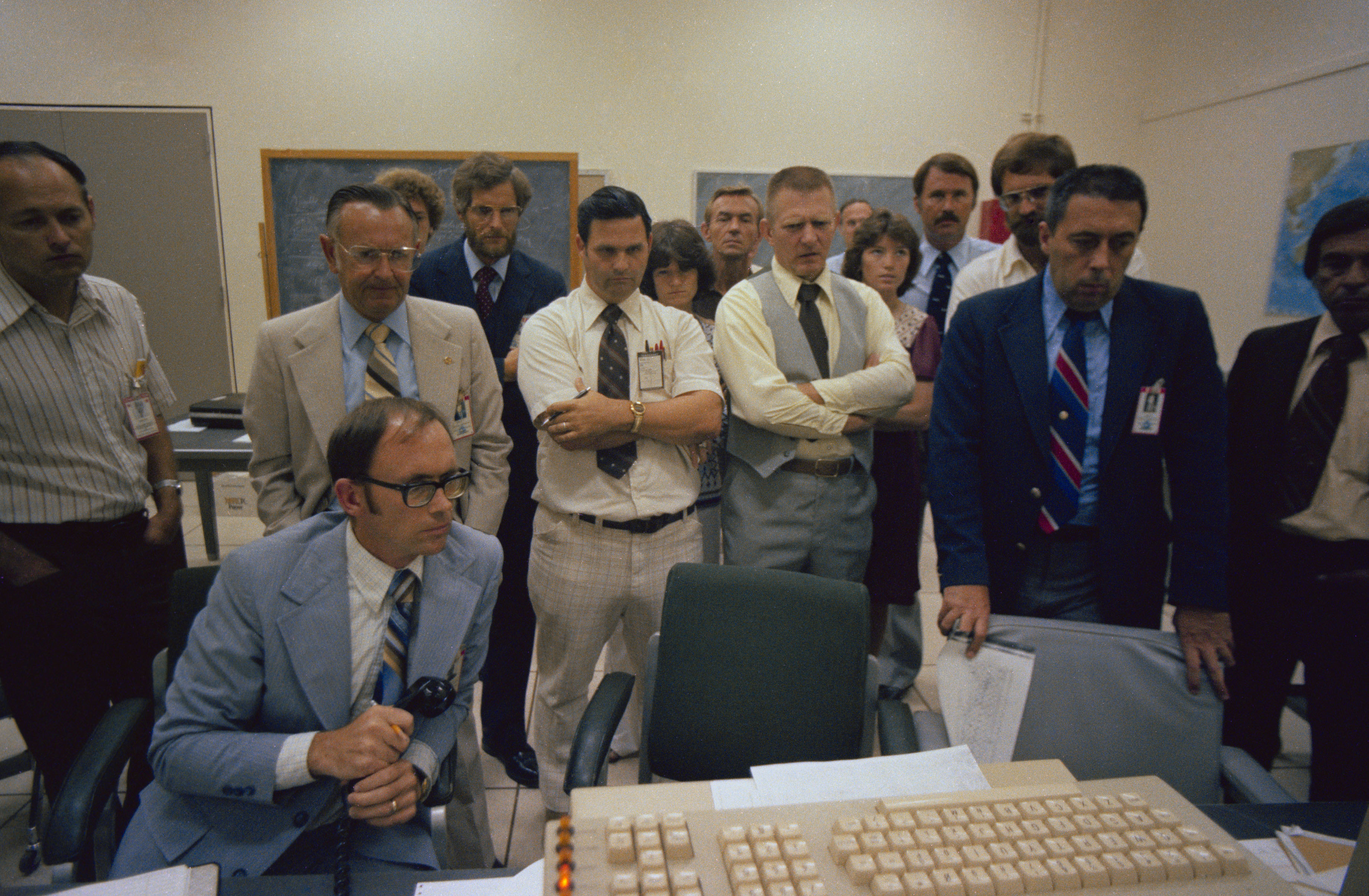Managers, flight directors, and astronauts monitor Skylab’s reentry from Mission Control at NASA’s Johnson Space Center in Houston