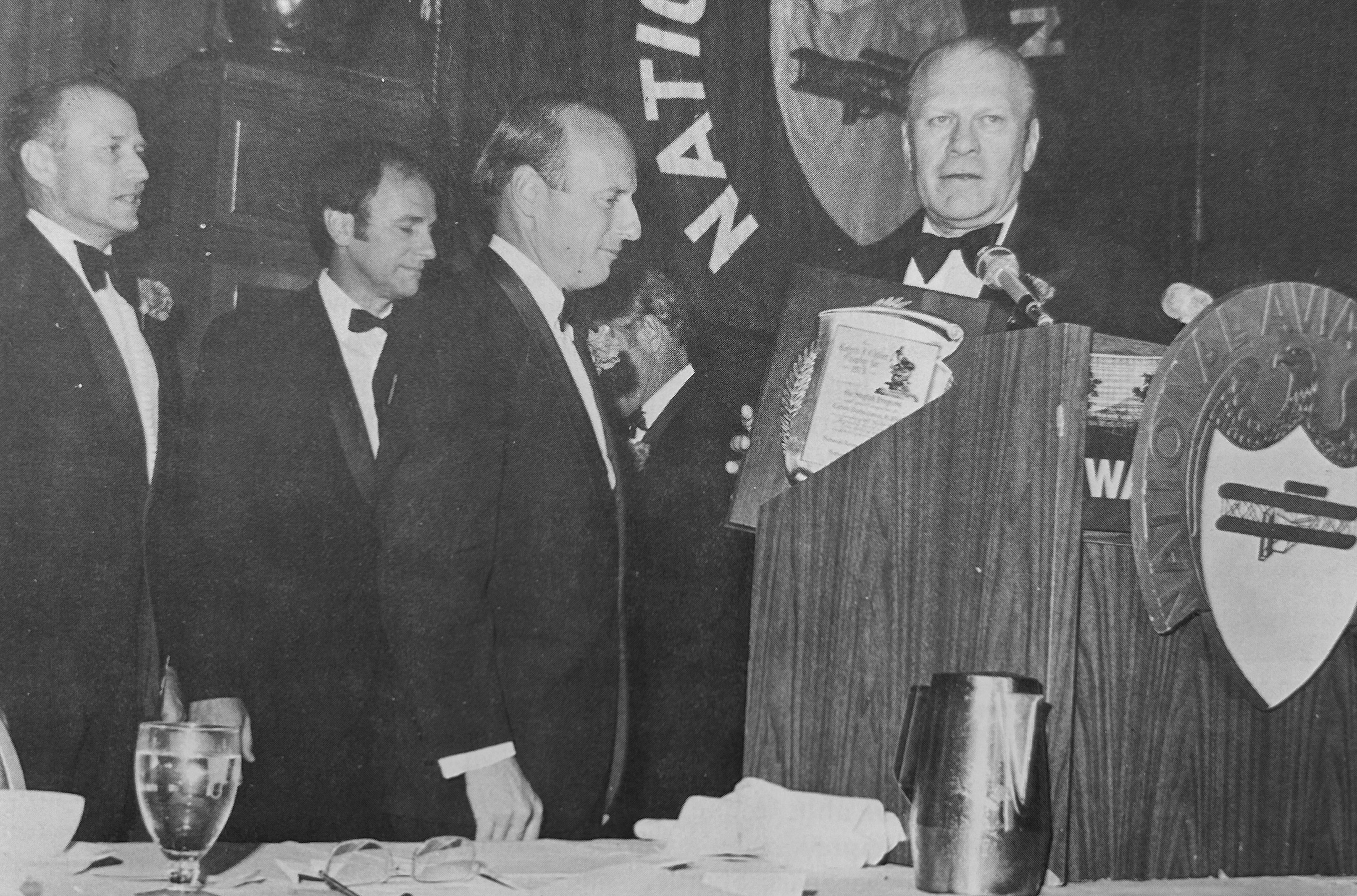 Skylab 2 Commander Charles “Pete” Conrad, center, accepts the Collier Trophy from Vice President Gerald R. Ford, right, as Skylab 4 Commander Gerald P. Carr, left, and Skylab 3 Commander Alan L. Bean look on