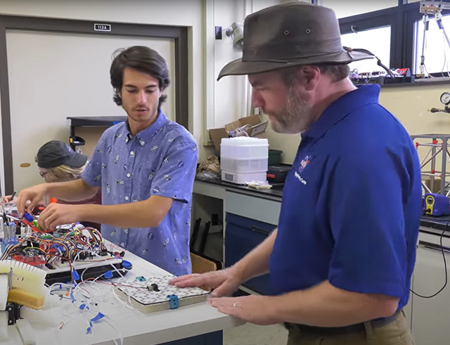 Soft robotics engineer Jim Neilan and mechanical engineering intern Anthony Dempsey working together