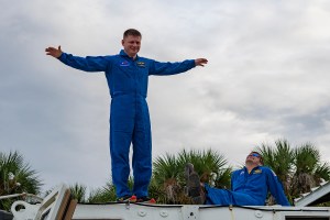 SpaceX Crew-8 Mission Specialist Alexander Grebenkin poses for a photo outside the emergency egress vehicle at NASA's Kennedy Space Center's Launch Pad 39A in Florida. Astronauts would use the emergency egress vehicle to quickly leave the launch area in the unlikely event of an emergency.