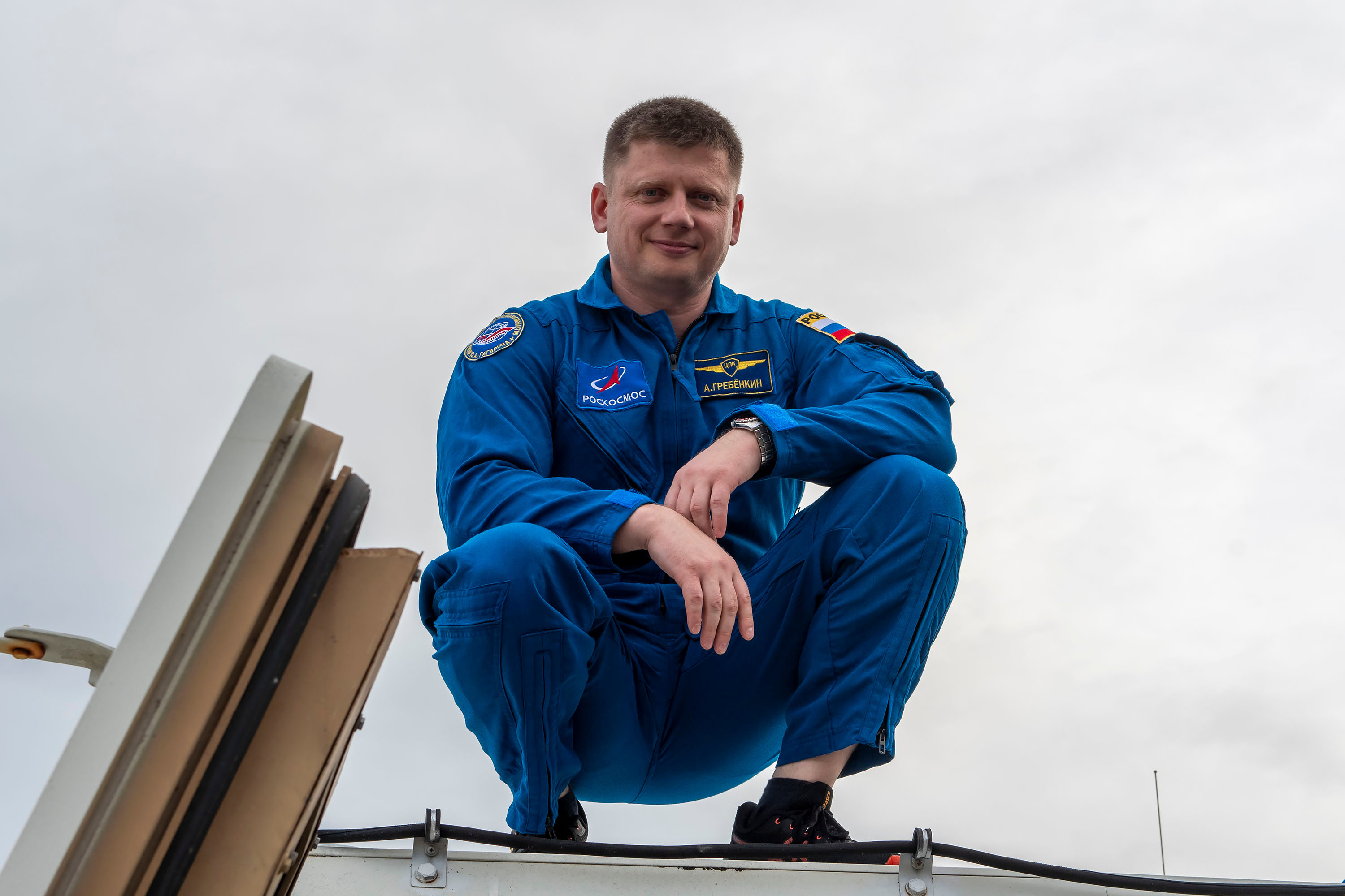 SpaceX Crew-8 Mission Specialist Alexander Grebenkin poses for a photo outside the emergency egress vehicle at NASA's Kennedy Space Center's Launch Pad 39A in Florida. Astronauts would use the emergency egress vehicle to quickly leave the launch area in the unlikely event of an emergency.