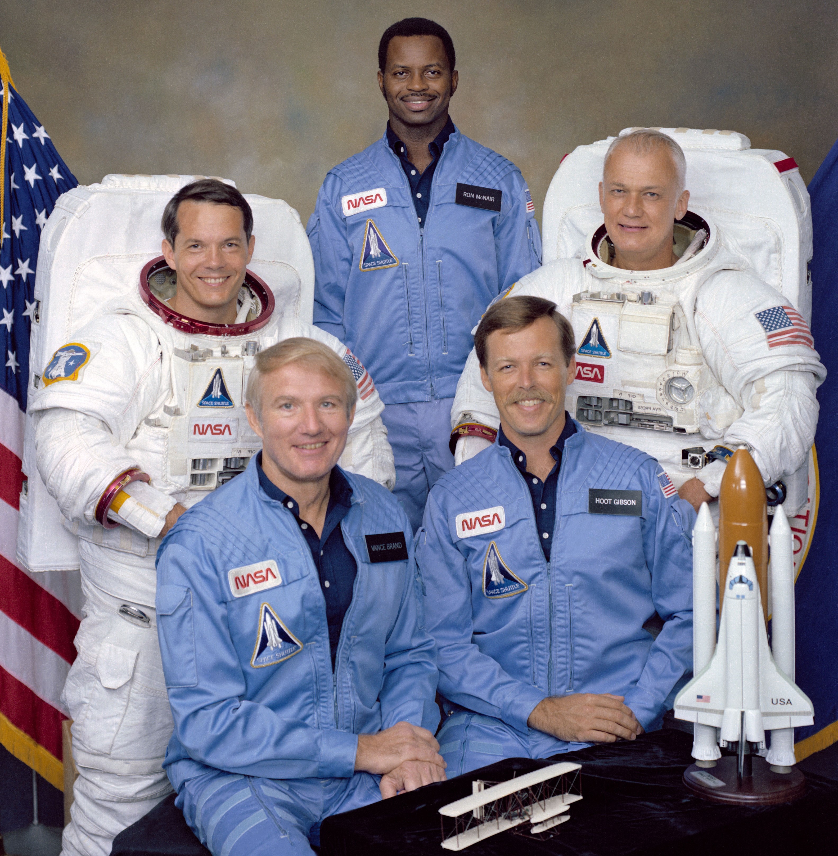 The STS-41B crew of Commander Vance D. Brand, Mission Specialists Robert L. Stewart, Ronald E. McNair, and Bruce McCandless, and Pilot Robert L. 