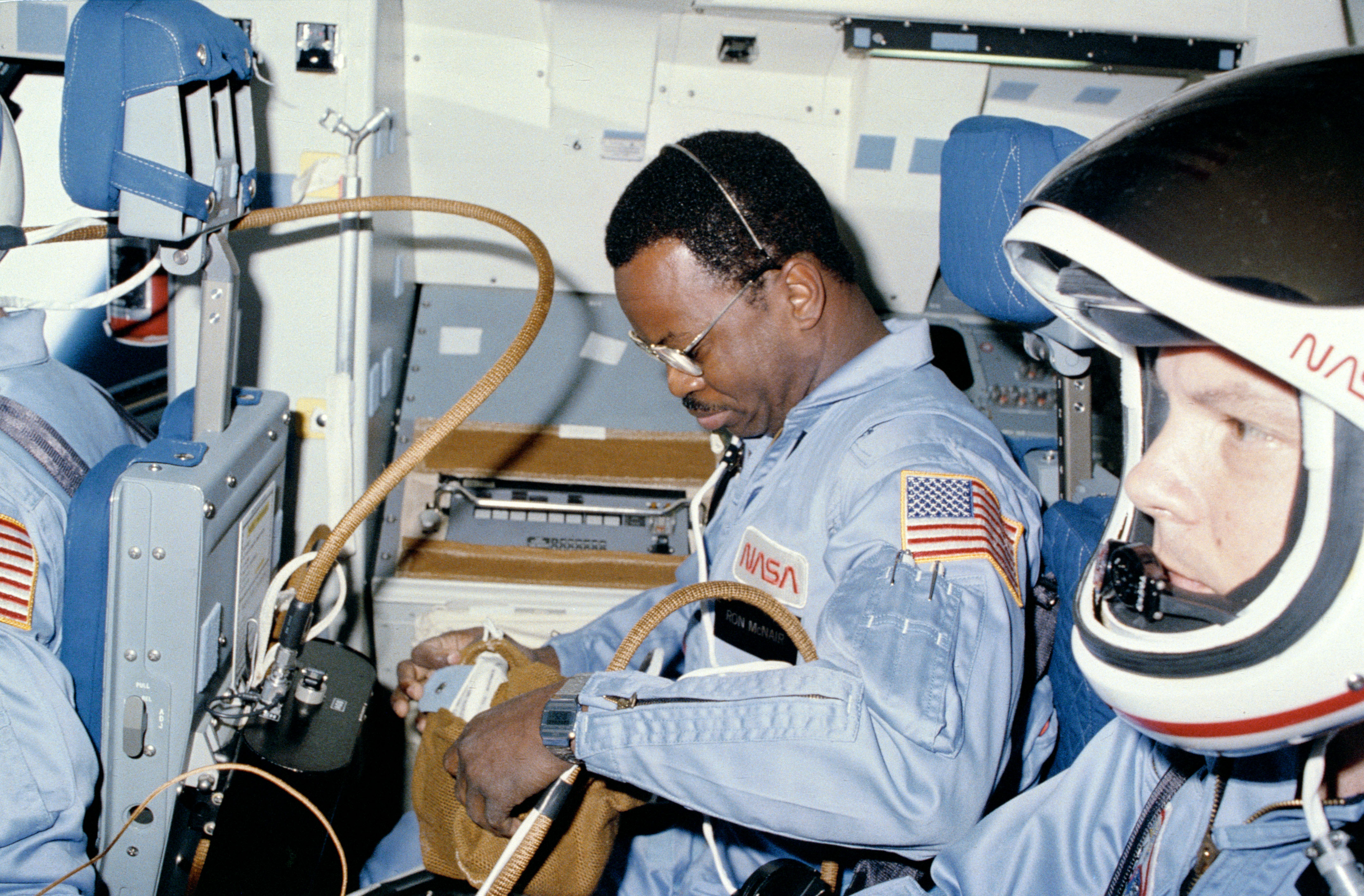 Astronauts Ronald E. McNair, left, and Robert L. Stewart minutes after Challenger reached orbit