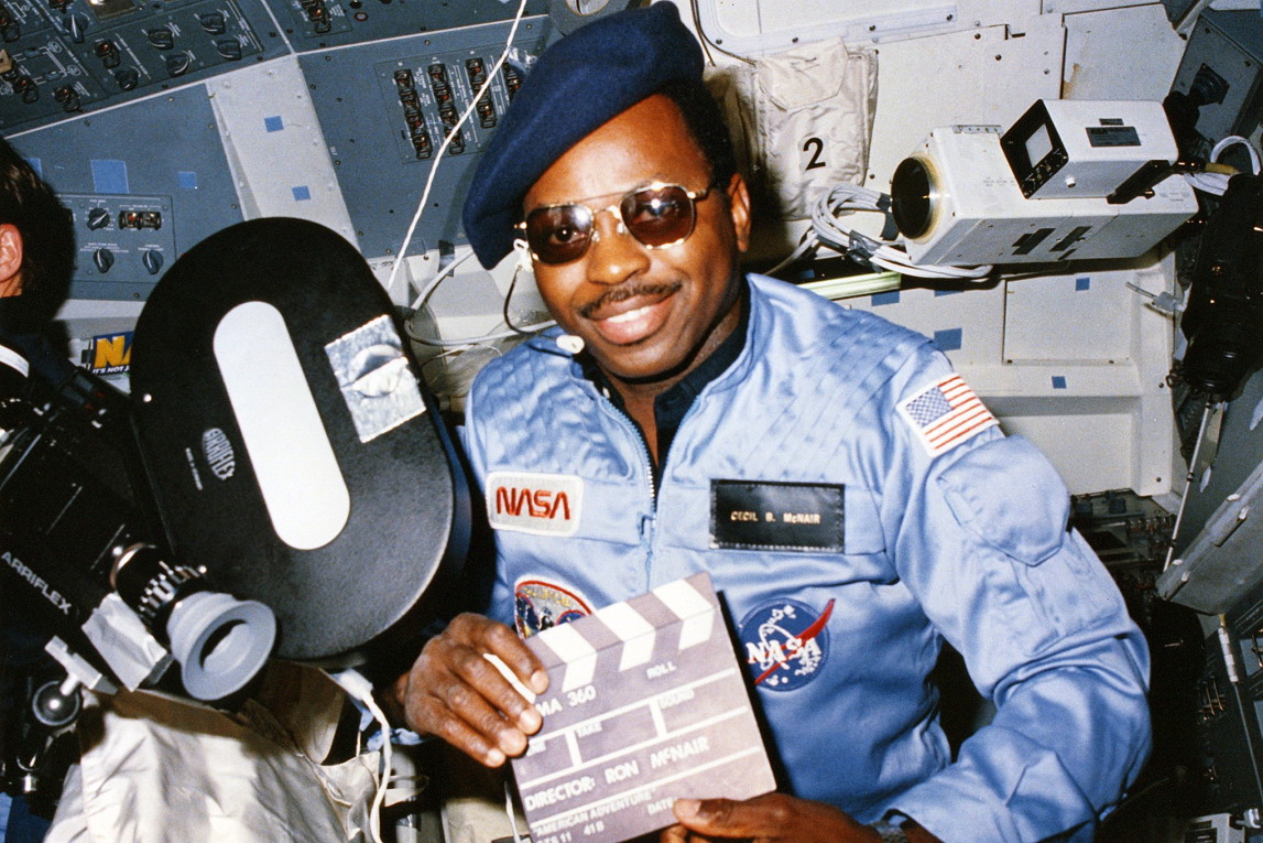 Astronaut Ronald E. McNair poses with the camera for the Cinema 360 project, wearing a humorous “Cecil B. McNair” name tag, sunglasses, and beret