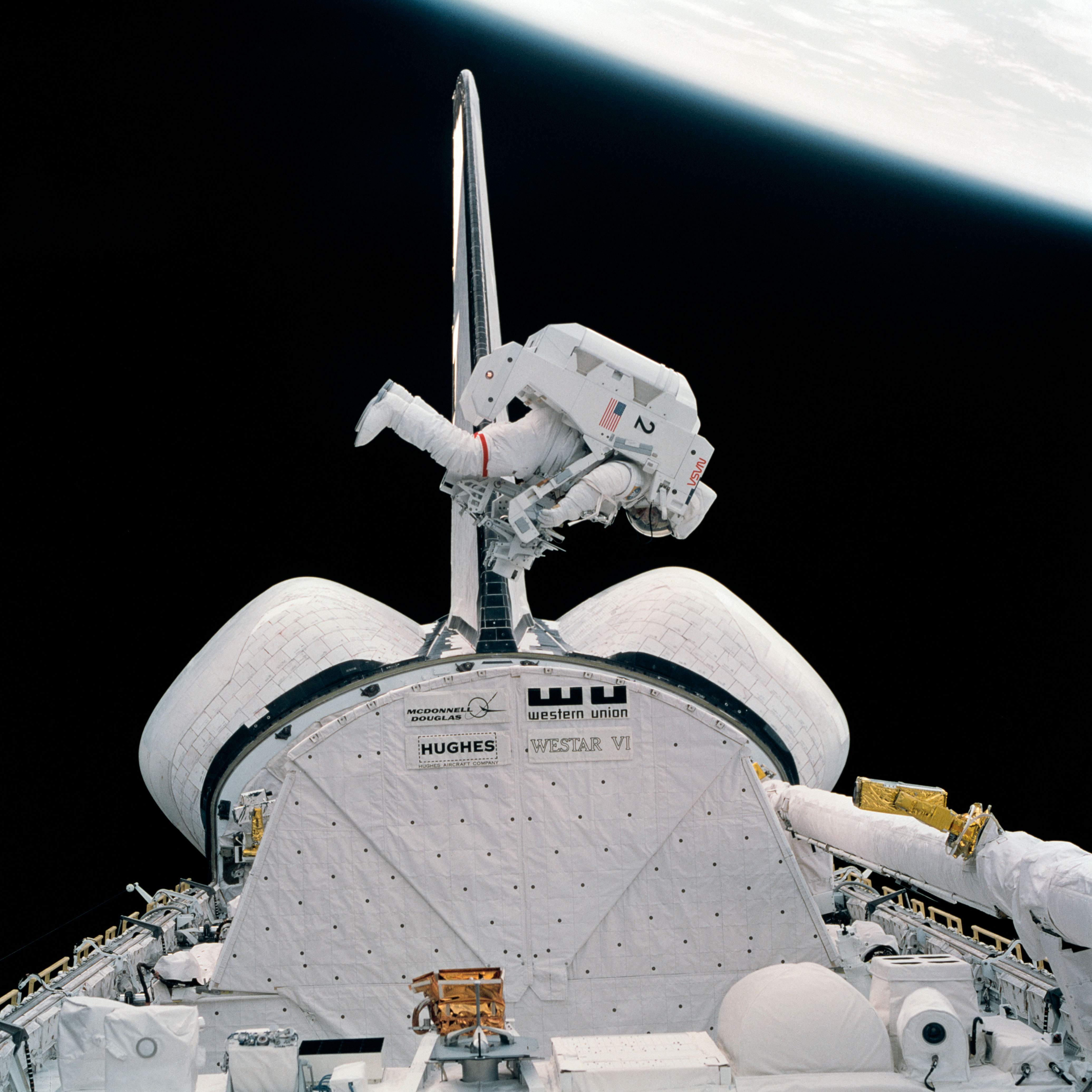 Bruce McCandless flies the Manned Maneuvering Unit (MMU) above Challenger’s payload bay during the second spacewalk