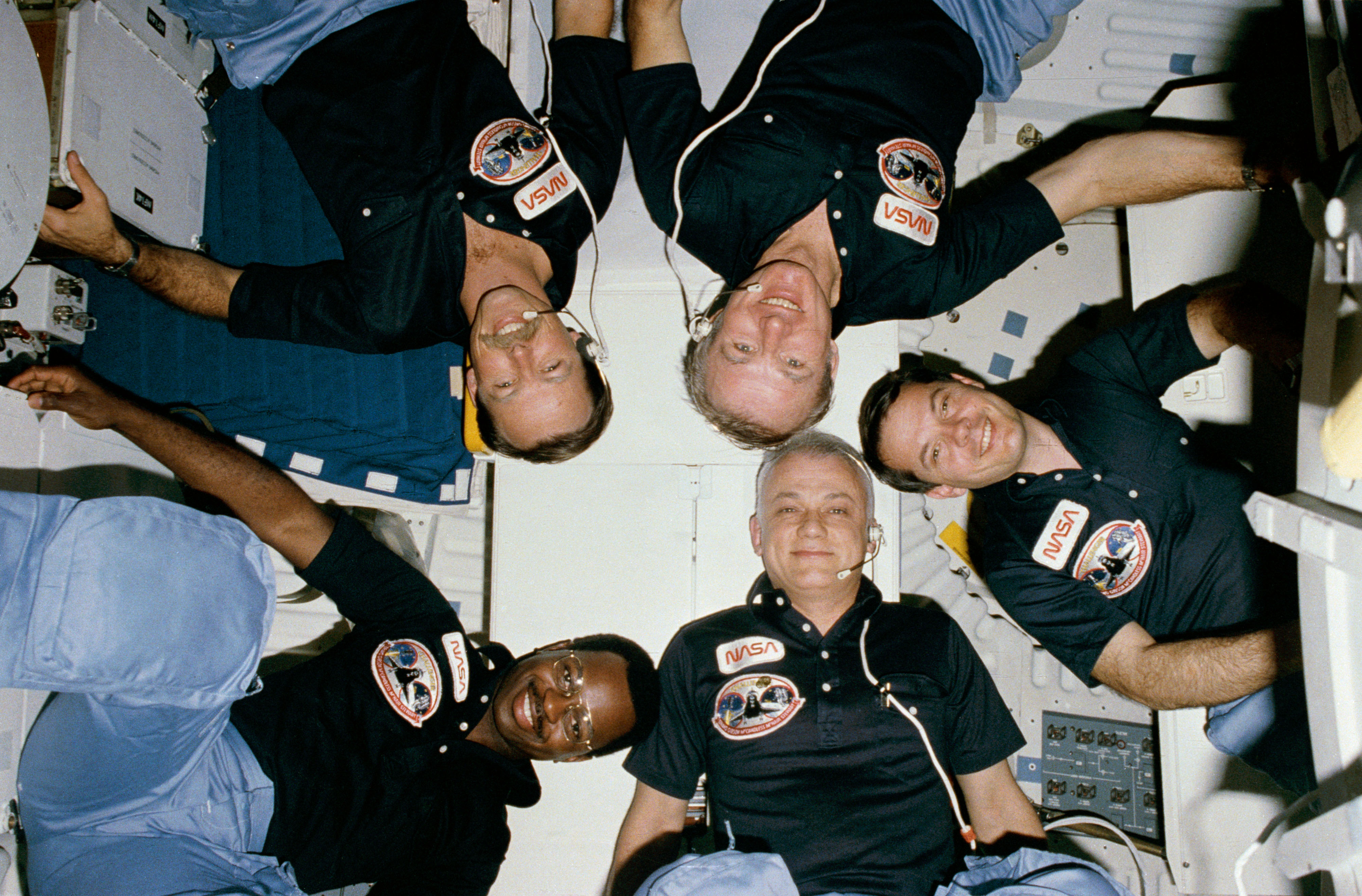 The STS-41B crew members pose near the end of their successful mission, in the middeck