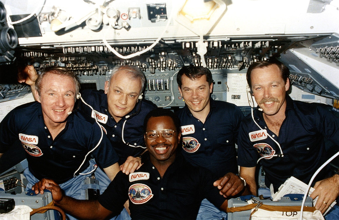 The STS-41B crew members pose near the end of their successful mission on the flight deck