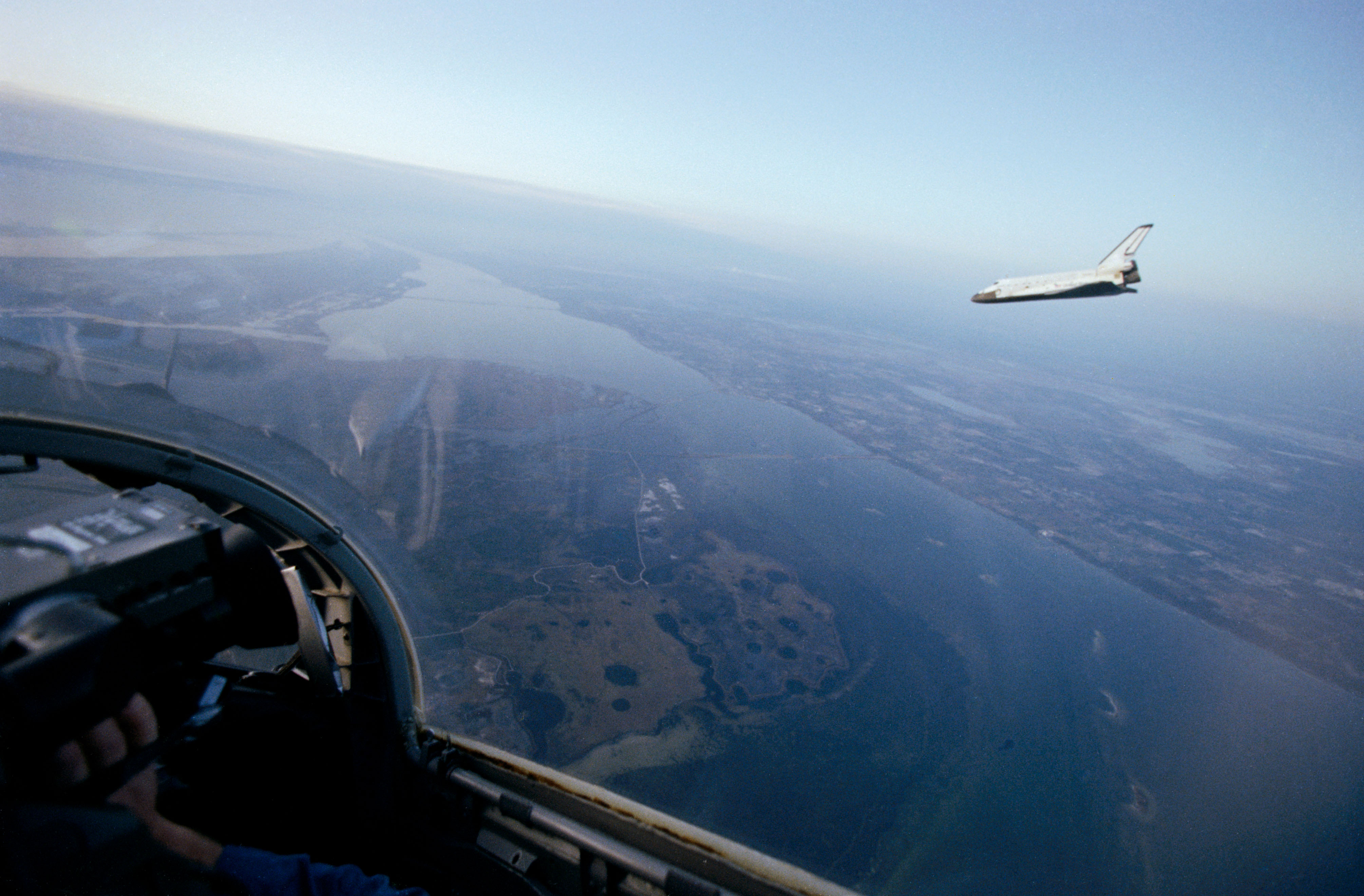 A chase plane photographs Challenger during its descent to NASA’s Kennedy Space Center in Florida