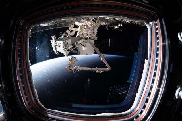 iss062e113107 (March 25, 2020) --- The Canadarm2 robotic arm and Dextre, the fine-tuned robotic hand, are remotely controlled on Earth to extract Bartolomeo from the pressurized trunk of the SpaceX Dragon resupply ship. Bartolomeo is a European Space Agency science payload system that will enable numerous external science experiments to be conducted and controlled outside the space station.