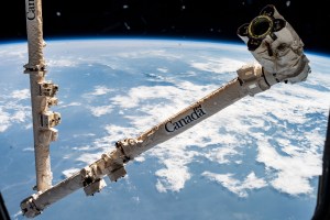 iss062e000422 (Feb. 7, 2020) --- The Canadarm2 robotic arm, from the Canadian Space Agency, is poised to capture the Cygnus space freighter from Northrop Grumman with NASA astronaut Andrew Morgan at the robotics controls in the cupola on Sunday, Feb. 16, 2020. Ground controllers will take over afterward and remotely command the Canadarm2 to install Cygnus to the Unity module where it will stay for three months.