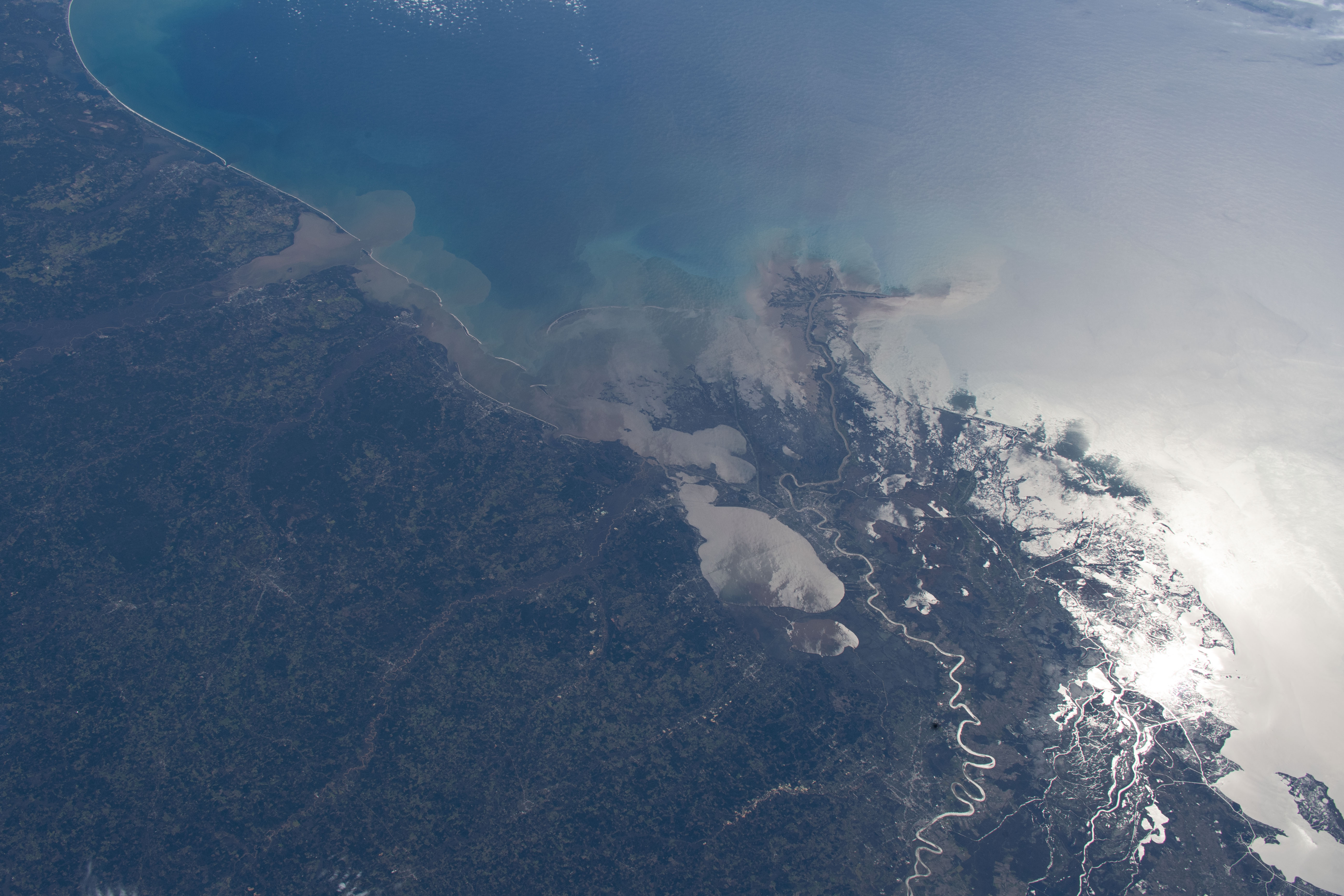 iss062e001793 (Feb. 7, 2020) --- The Mississippi River runs past Lake Pontchartrain, through the city of New Orleans, Louisiana, and into the Gulf of Mexico beaming from the Sun's glint.