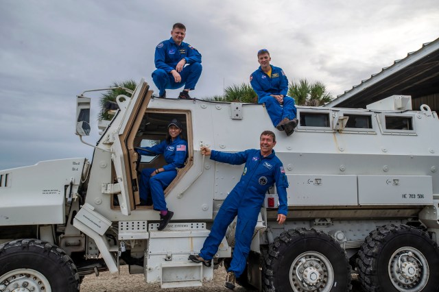 The crew members of NASA's SpaceX Crew-8 mission pose for a photo at an emergency egress vehicle at NASA's Kennedy Space Center's Launch Pad 39A in Florida. Clockwise from top left are, Mission Specialist Alexander Grebenkin, Commander Matthew Dominick, Pilot Michael Barratt, and Mission Specialist Jeanette Epps.. Astronauts would use the emergency egress vehicle to quickly leave the launch area in the unlikely event of an emergency.