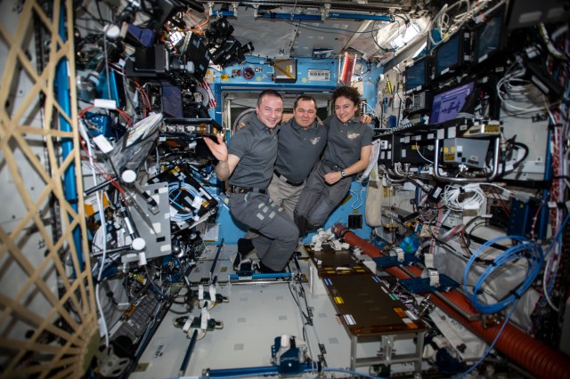 iss062e037602 (Feb. 20, 2020) --- The Expedition 62 crew poses for a portrait aboard the International Space Station's U.S. Destiny laboratory module. Roscosmos Commander Oleg Skripochka, in the middle, is flanked by NASA Flight Engineers Andrew Morgan and Jessica Meir.