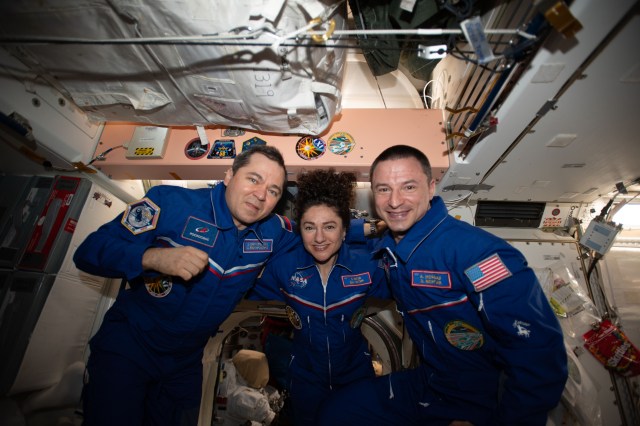 iss062e149997 (April 15, 2020) --- The Expedition 62 crew poses for a portrait inside the International Space Station's Unity module that links the orbiting lab's U.S. and Russian segments. From left are, Roscosmos cosmonaut Oleg Skripochka with NASA astronauts Jessica Meir and Andrew Morgan.