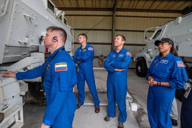 The four crew members of NASA's SpaceX Crew-8 mission train outside an emergency egress vehicle at NASA's Kennedy Space Center's Launch Pad 39A in Florida. From left are, Mission Specialist Alexander Grebenkin, Commander Matthew Dominick, Pilot Michael Barratt, and Mission Specialist Jeanette Epps. Astronauts would use the emergency egress vehicle to quickly leave the launch area in the unlikely event of an emergency.