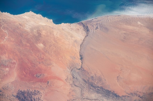 iss062e103100 (March 20, 2020) --- The Orange River empties into the Atlantic Ocean and separates the nations of Namibia and South Africa. The International Space Station was orbiting 265 miles above the African continent when this photograph was taken.