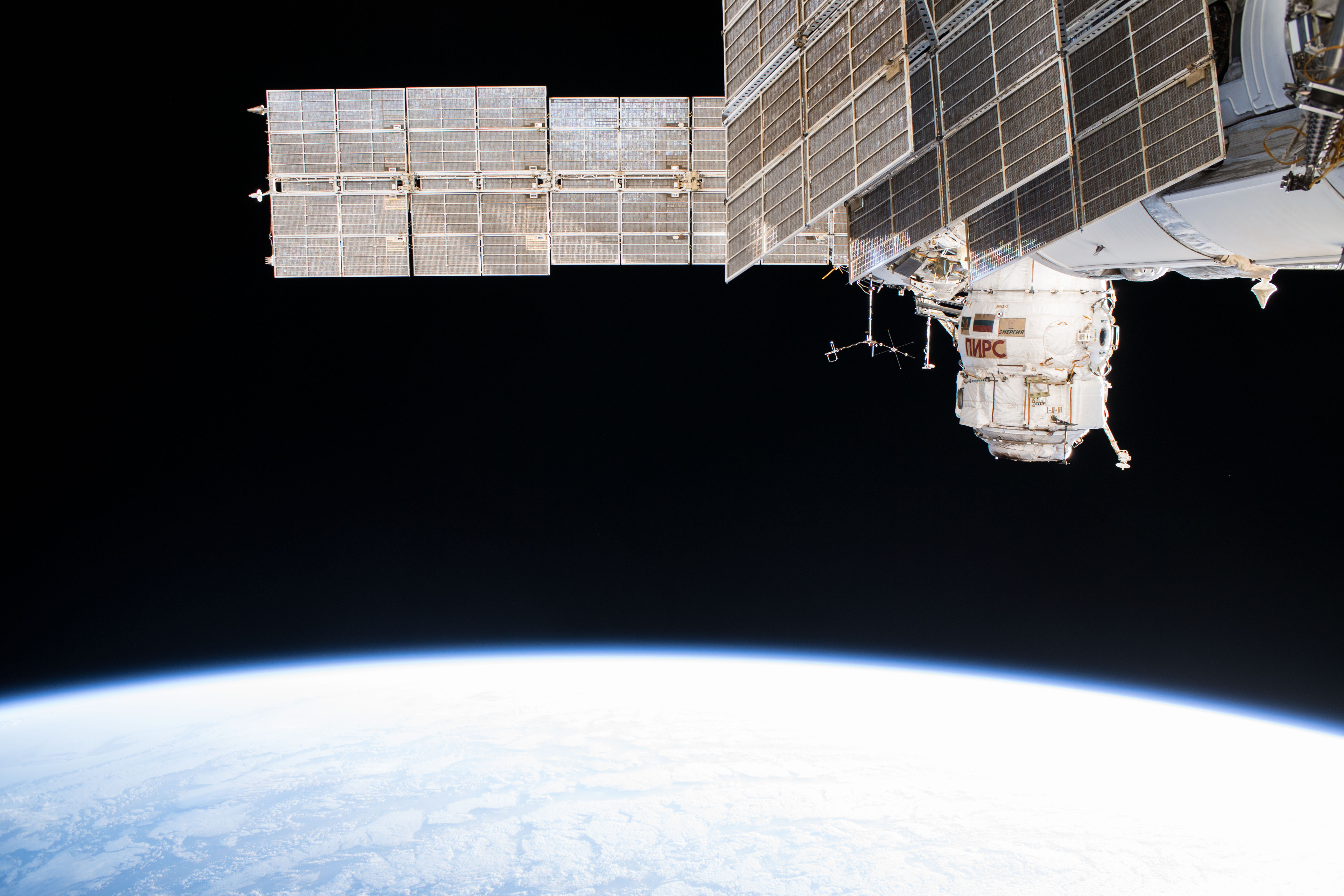 The Russian segment of the International Space Station is photographed as the complex orbited off the northwest coast of Spain. The dominant Russian segment features seen in this picture include the Pirs docking compartment and the solar arrays belonging to the Zarya and Zvezda modules.