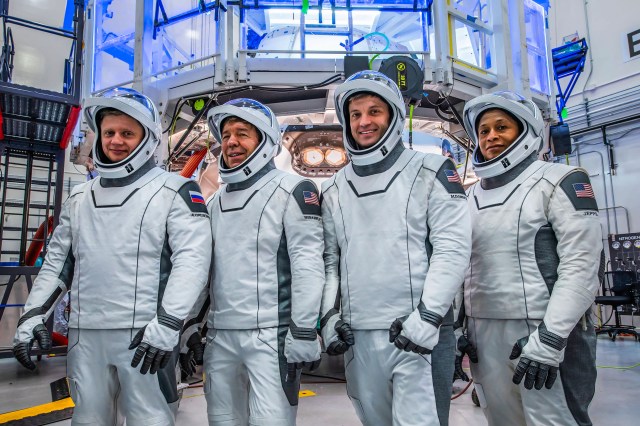 (Left to right) Roscosmos Cosmonaut Alexander Grebenkin and NASA Astronauts Michael Barratt, Matthew Dominick, and Jeanette Epps pose for a photo during their Crew Equipment Interface Test at NASA’s Kennedy Space Center in Florida. The goal of the training is to rehearse launch day activities and get a close look at the spacecraft that will take them to the International Space Station.