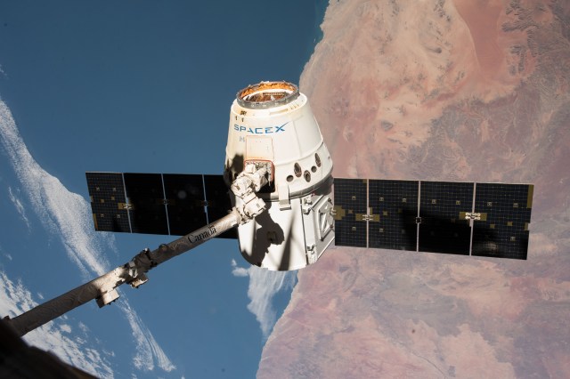 The SpaceX Dragon cargo craft is pictured in the grips of the Canadarm2 robotic arm as the International Space Station was orbiting across the central coast of Namibia. Dragon was later released for its splashdown in the Pacific Ocean off the coast of California on May 5, 2018 ending the SpaceX CRS-14 mission.